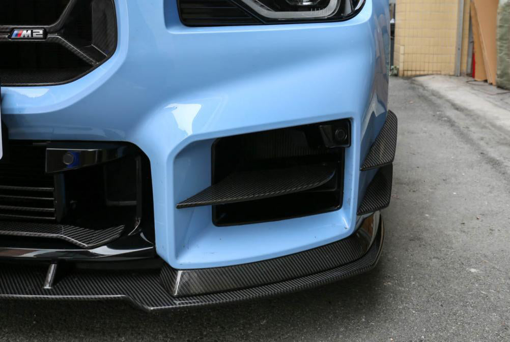AC Type Bumper Ducts Trim in dry carbon fiber for the BMW G87 M2, fitted