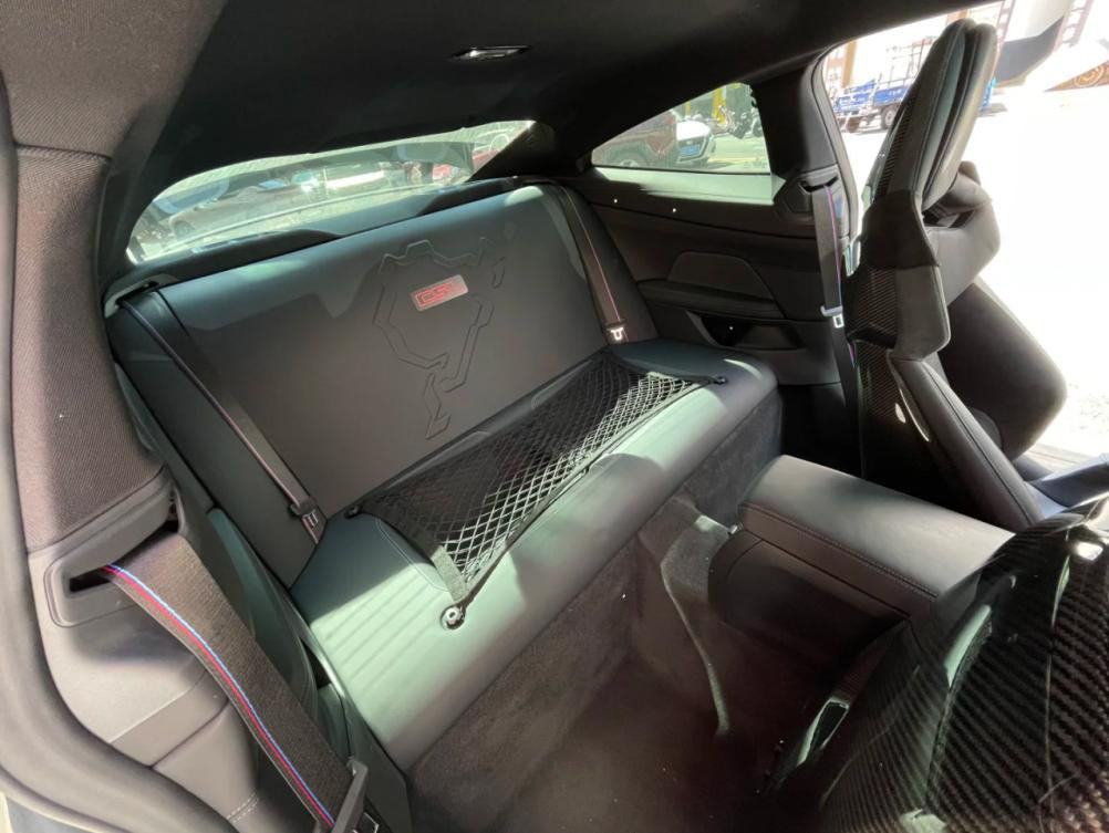 CSL Rear Seat Removal Kit in dry carbon fiber for the BMW G80 M3 / G82 M4 / G87 M2, fitted